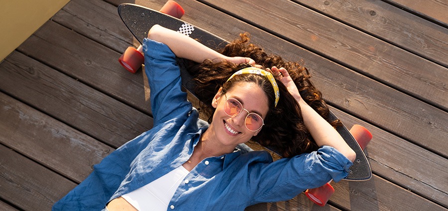 woman relaxing with her skateboard outside. buy weed online in Canada. 