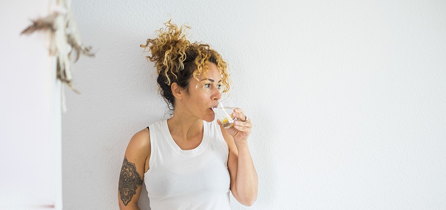 Woman drinking water from a glass. buy weeds online. mail order weed canada. weed online. 