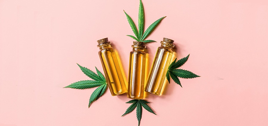 thc distillate bottles and cannabis leaves. What is THC distillate? Buy cannabis concentrates online. Buy weed online in Canada.