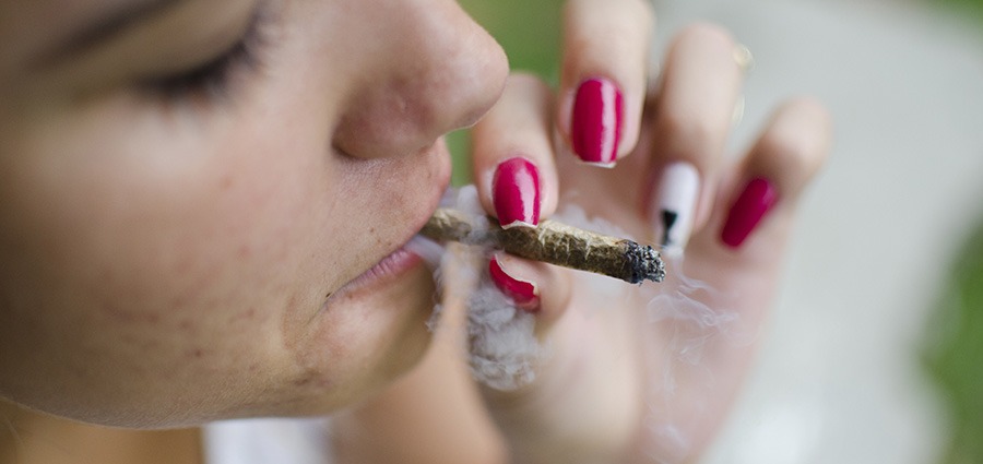 Woman smoking a joint after buying weed online from BC cannabis stores and online dispensary.