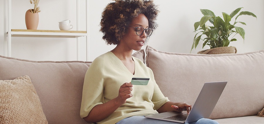 african american woman pays online with credit card online cannabis shopping | My Green Solution