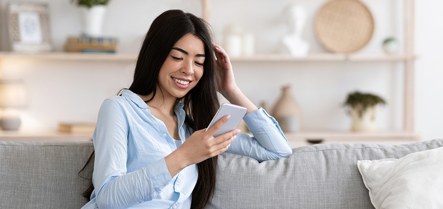 Woman searching on her phone for where to buy weed in Surrey from an online dispensary or mail order marijuana weed store. Buy weed online Canada.
